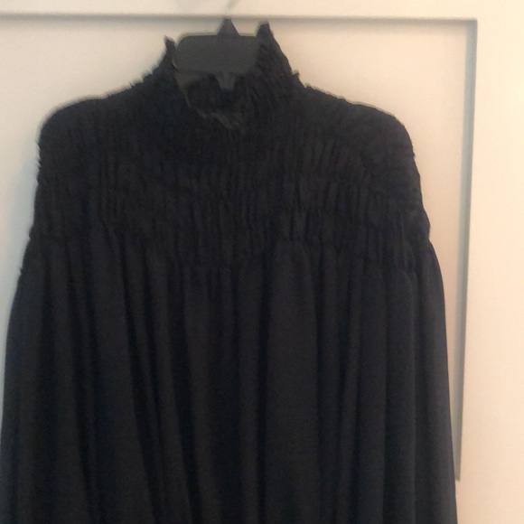 Frame sheer top with elastic detail around the yoke area. Black - Picture 2 of 6